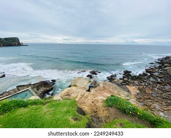 Man sitting next to Beach beautiful beach scene. water ocean