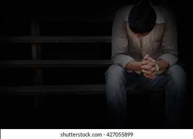 A Man Sitting At An Old Wooden Stairs And A Sad Mood. Dark Concept 