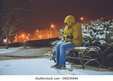 Man Sitting On A Bench In Cold Winter Night Frozen