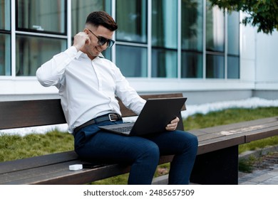Man Sitting on Bench Using Laptop Computer
