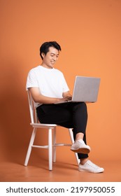 Man Sitting On Chair  Isolated On Orange Background