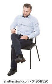 Man Sitting On Chair. Isolated White Background. Removes Dust Particles, Looking Down