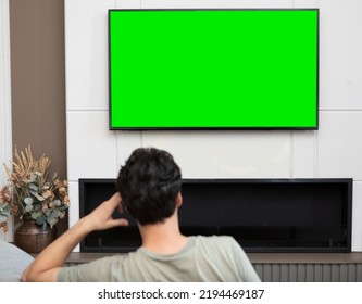 Man Sitting On The Couch And Watching Tv. Green Screen Concept