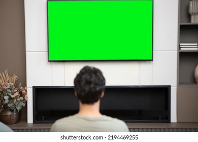 Man Sitting On The Couch And Watching Tv. Green Screen Concept