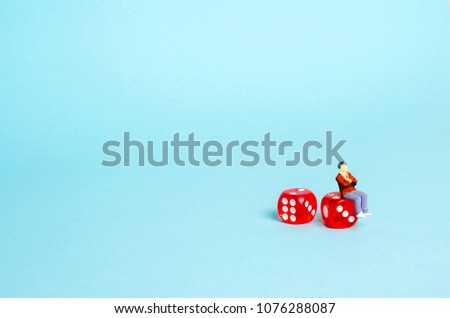 A man is sitting on dice and thinking about money on a white background. The concept of gambling. Probability theory. Lose in the casino. Bookmakers, playing on the stock exchange