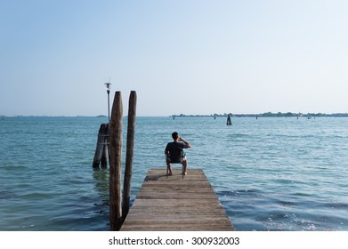 Man is sitting on dock