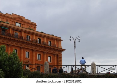 Man sitting on fence in Rome
