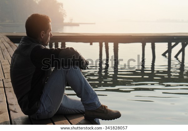 Man Sitting On Old Wooden Dock Stock Photo (Edit Now) 341828057