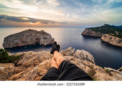 Man sitting on a rock enjoying the view of the cliff in the north of Sardinia - Powered by Shutterstock