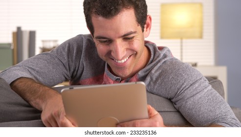 Man sitting on sofa and using tablet