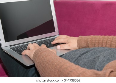 Man sitting on the sofa using a laptop