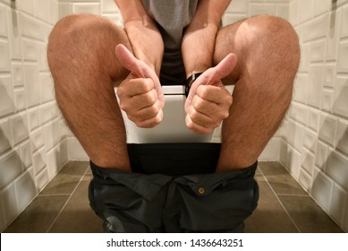 Man Sitting On Toilet Defecating