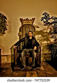 Man Sitting On Vintage Kings Throne