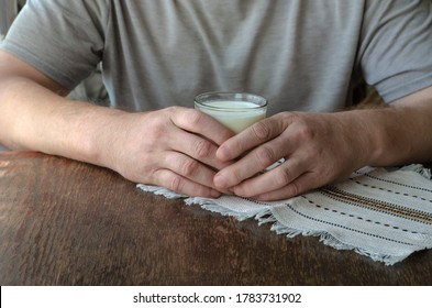 Man Sitting At The Table With Glass Of Kefir In His Hands. The Use Of Kefir For Food. Adult Male, Caucasian. Age 44-45. Lifestyle.