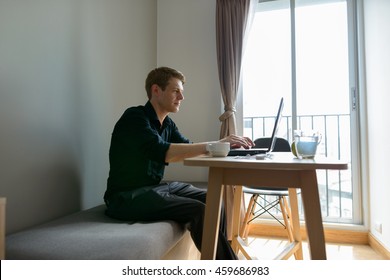 Man sitting at table using laptop computer