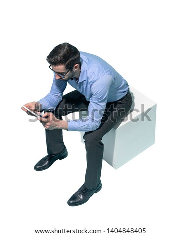 Man sitting and using apps on a digital tablet, white background