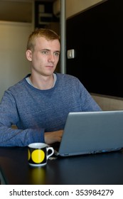 Man sitting and using laptop computer in his home