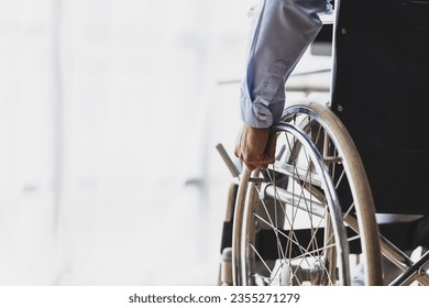 Man sitting in wheelchair at home.