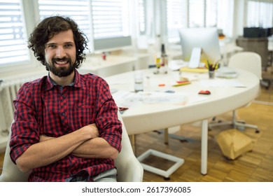 Man sitting at white desk in open plan office using papers sticky notes pencils, copy space. Workspace, creativity, productivity, brainstorming, focus, innovation, organization