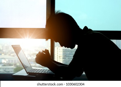 Man Sitting Work Computer He Operation Failed. Stress With Headache Not Happy At He Desk In Office Background Window View City . Health And Technology Concept