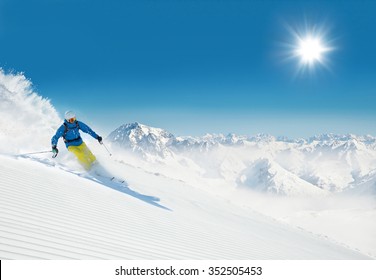 Man Skier Running Downhill On Sunny Alpine Slope