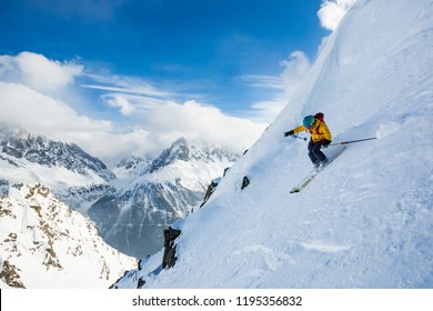 A Man Is Skiing Down The Hill On The Steep Slope In Alps. Chamonix. High Mountain Area.