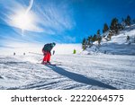 Man skiing down the ski slope or piste in Pyrenees Mountains. Winter ski holidays in El Tarter, Grandvalira, Andorra