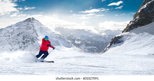 Man skiing on the prepared slope with fresh new powder snow in Alps 