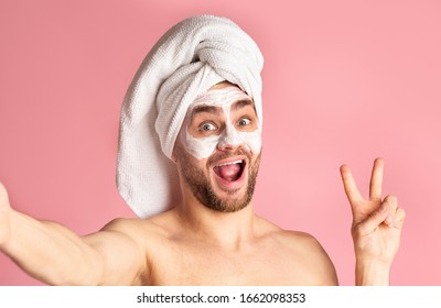 Man Skin Care And Selfie. Millennial Guy With Mask On His Face Shows Peace Sign