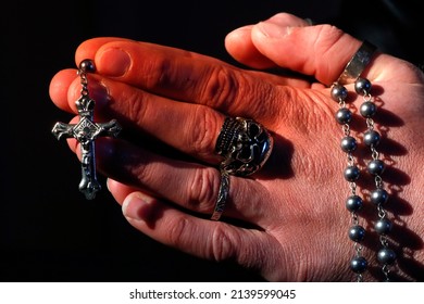 Man With Skull Ring  Praying The The Rosary. Close-up.  France.