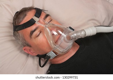 Man With Sleep Apnea And CPAP Machine