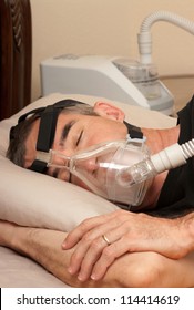 Man with sleeping apnea and CPAP machine