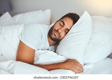 Man, sleeping and bed in morning rest for healthy wellness, peace and quiet on comfort pillow at home. Tired or exhausted male person asleep or dreaming on peaceful holiday or weekend in the bedroom