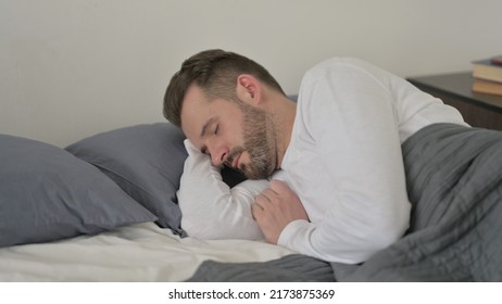 Man Sleeping in Bed Peacefully - Shutterstock ID 2173875369