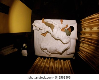 Man Sleeping In The Bed Shot Top View. So Alone In The Bedroom.