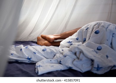 Man Sleeping Behind Mosquito Net