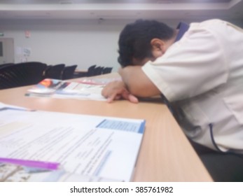Man sleeping in classrooms.Photo out of focus and 
manual focus.Photo is blur.