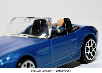 man sleeping in his car - miniature
