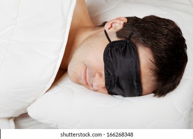 Man With Sleeping Mask Sleep Lying In Bed