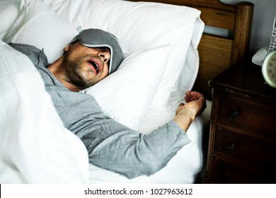 A man sleeping on a bed