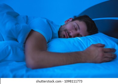 The Man Sleeping On The Bed. Evening Night Time