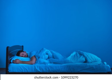 The Man Sleeping On The Bed. Evening Night Time