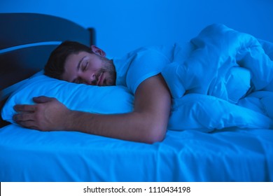 The Man Sleeping On The Bed. Evening Night Time