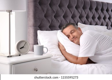 Man Sleeping On Comfortable Pillow In Bed At Home