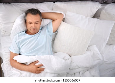 Man Sleeping On Comfortable Pillow In Bed At Home, Top View