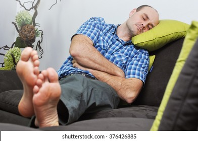 Man Sleeping On A Couch