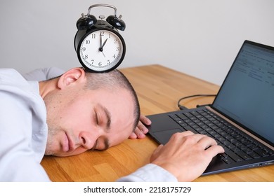 Man Sleeping On Table With Alarm Clock On Head Next To Laptop At Workplace, Burnout Concept