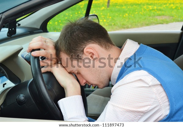 man sleeps in a\
car