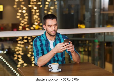 Man With Smartphone And Coffee At Restaurant