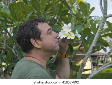 Man  Smelling Spring Flowers.